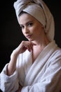 Young woman in a bathrobe and towel on her head, spa and care portrait, clean face Royalty Free Stock Photo