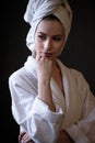 Young woman in a bathrobe and towel on her head, spa and care portrait, clean face Royalty Free Stock Photo