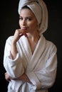 Young woman in a bathrobe and towel on her head, spa and care portrait, clean face Royalty Free Stock Photo