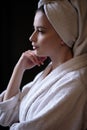 Young woman in a bathrobe and towel on her head, spa and care portrait, clean face Royalty Free Stock Photo