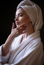 Young woman in a bathrobe and towel on her head, spa and care portrait, clean face Royalty Free Stock Photo