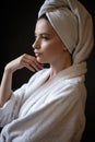 Young woman in a bathrobe and towel on her head, spa and care portrait, clean face Royalty Free Stock Photo