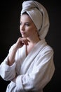 Young woman in a bathrobe and towel on her head, spa and care portrait, clean face Royalty Free Stock Photo