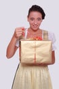 Young woman in Bavarian Dirndl grabs a gift from Royalty Free Stock Photo