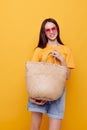 young woman Beach bag fashion in yellow t-shirt denim shorts Lifestyle unaltered Royalty Free Stock Photo