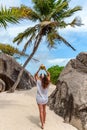 Young woman in beach clothes standing on sandy path leading to exotic tropical beach Royalty Free Stock Photo