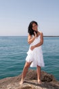 young woman on the beach enjoying the good weather near the sea