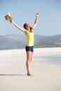 Young woman on the beach with hands wide open Royalty Free Stock Photo