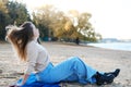 Young woman on the beach in jeans and a sweater. stress-free concept. Slow living. Enjoying the little things. Lykke