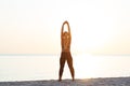 Young woman at the beach stretching after workout Royalty Free Stock Photo