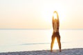 Young woman at the beach stretching after workout Royalty Free Stock Photo