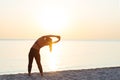 Young woman at the beach stretching after workout Royalty Free Stock Photo