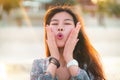 Young woman on a beach with surprised face expressing Wow emotion for amazed concept Royalty Free Stock Photo