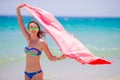 Young woman with beach towel during tropical vacation. Beautiful girl enjoy her summer holidays. Royalty Free Stock Photo