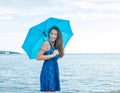 Young Woman on Beach with Pantone Turquoise Umbrella and Dress