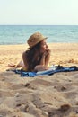 Young Woman on the Beach wearing a Straw Hat