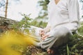 Young woman with beads practice yoga outdoors in the forest. New normal social distance. Physical and mental health Royalty Free Stock Photo