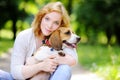 Young woman with Beagle dog in the park Royalty Free Stock Photo