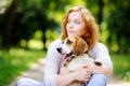 Young woman with Beagle dog in the summer park Royalty Free Stock Photo