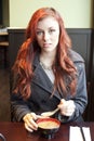 Young Woman with Beautiful Auburn Hair Eating Miso Soup.