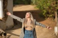 Young woman, beautiful, blonde and with closed eyes, with jacket, denim skirt, with open arms, relaxed, very happy and smiling. Royalty Free Stock Photo