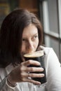 Young Woman with Beautiful Brown Eyes Drinking a Pint of Stout Royalty Free Stock Photo