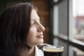 Young Woman with Beautiful Brown Eyes Drinking a Pint of Stout Royalty Free Stock Photo