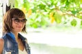 Young woman in beautiful dress and sunglasses posing in gazebo. Tropical island Bali, Indonesia. Portrait of young Royalty Free Stock Photo