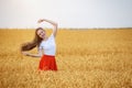 Young woman with beautiful long hair standing among ripe wheat. Hair care Royalty Free Stock Photo