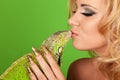 Young woman with beautiful manicure kissing a igua