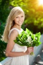 Young woman with a beautiful smile with healthy teeth with flowers. Face of a beautiful positive girl Concept on the subject Royalty Free Stock Photo