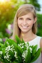 Young woman with a beautiful smile with healthy teeth with flowers. Face of a beautiful positive girl Concept on the subject Royalty Free Stock Photo