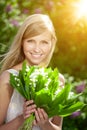 Young woman with a beautiful smile with healthy teeth with flowers. Face of a beautiful positive girl Concept on the subject Royalty Free Stock Photo