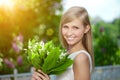 Young woman with a beautiful smile with healthy teeth with flowers. Face of a beautiful positive girl Concept on the subject Royalty Free Stock Photo