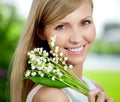 Young woman with a beautiful smile with healthy teeth with flowers. Face of a beautiful positive girl Concept on the subject Royalty Free Stock Photo