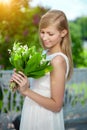 Young woman with a beautiful smile with healthy teeth with flowers. Face of a beautiful positive girl Concept on the subject Royalty Free Stock Photo