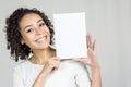 Young woman with a beautiful smile is holding a blank board Royalty Free Stock Photo