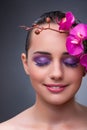 The young woman in beauty concept with orchid flower Royalty Free Stock Photo