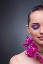 The young woman in beauty concept with orchid flower Royalty Free Stock Photo