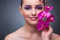 The young woman in beauty concept with orchid flower Royalty Free Stock Photo