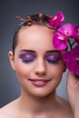 The young woman in beauty concept with orchid flower Royalty Free Stock Photo