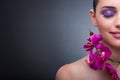 The young woman in beauty concept with orchid flower Royalty Free Stock Photo