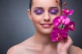 The young woman in beauty concept with orchid flower Royalty Free Stock Photo