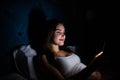 Young woman on bed late at night texting using mobile phone sleepy and tired in internet communication overuse concept and smart p Royalty Free Stock Photo