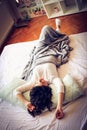 Young woman on a bed at morning. Above view.