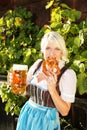 Young woman with beer glasses and bretzel