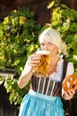 Young woman with beer glasses and bretzel