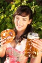 Young woman with beer glasses and bretzel