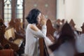 Young woman begging forgiveness in church