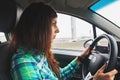 Young woman beginner driver driving